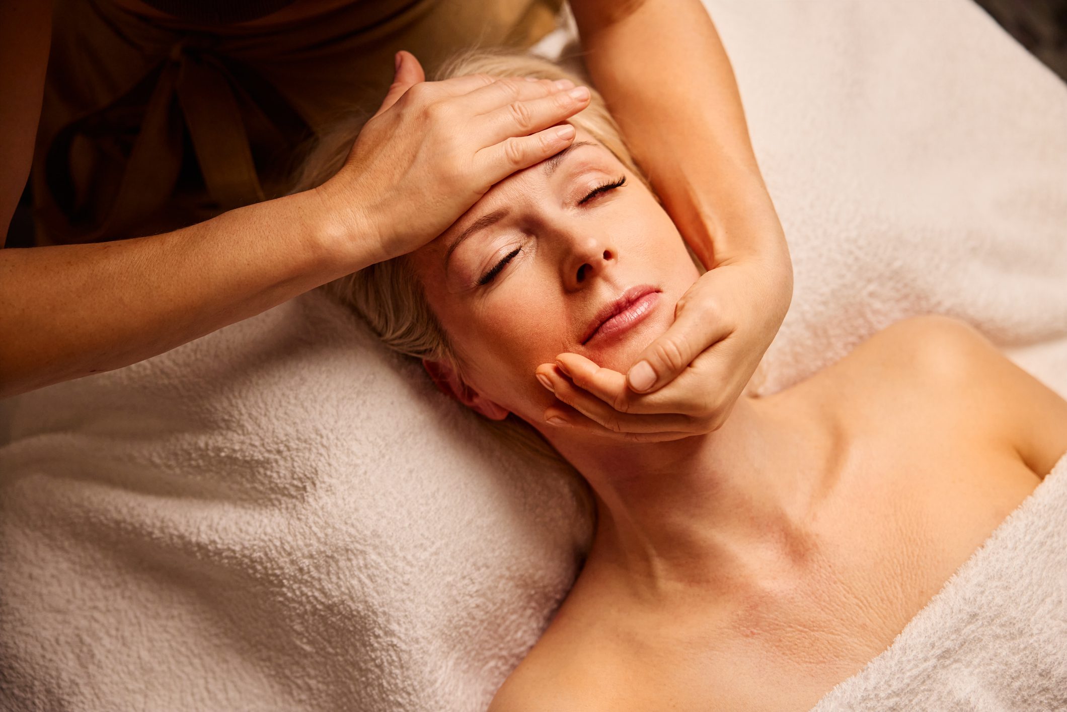 Mature Woman Enjoying a Tranquil Face Massage Therapy Session